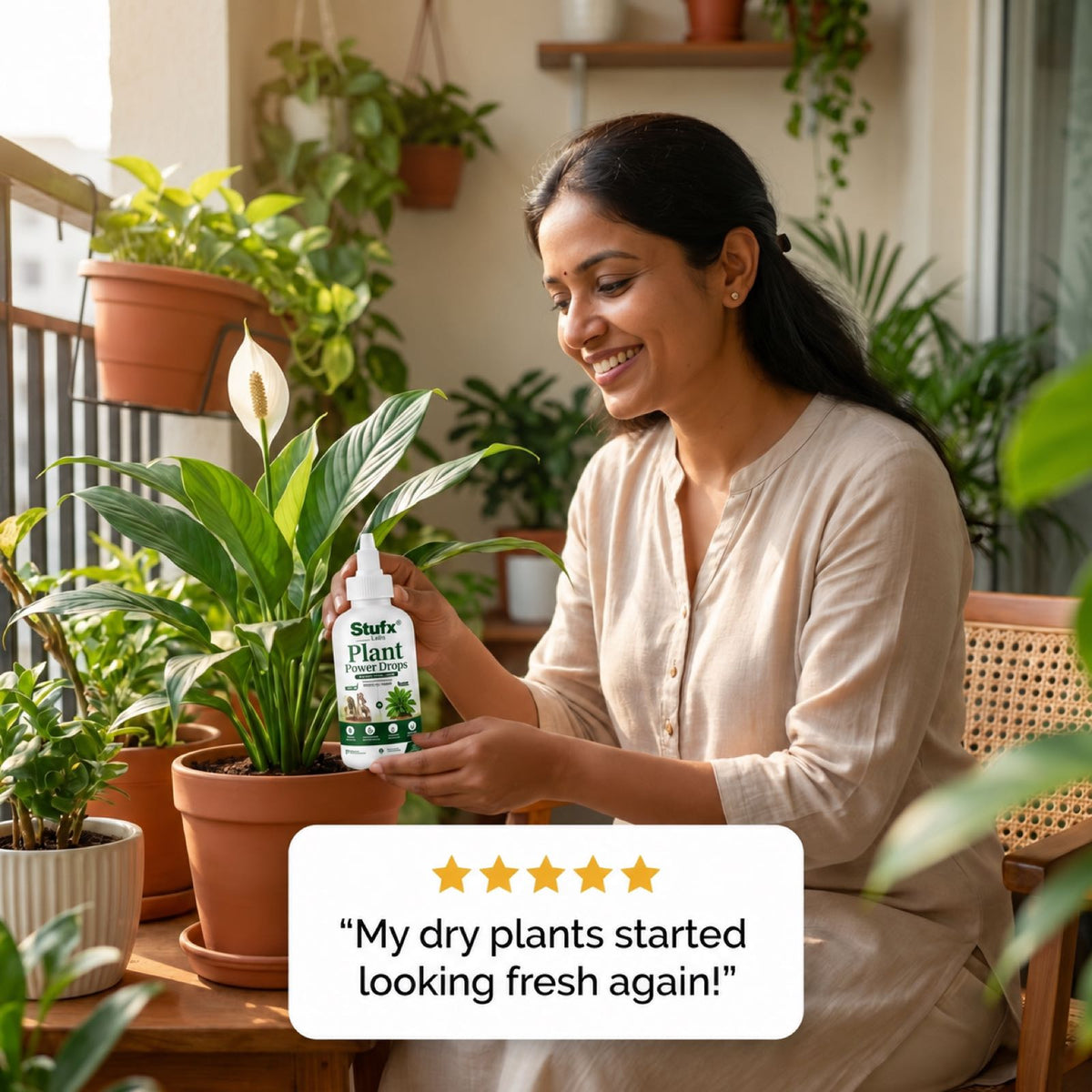 Woman holding Plant Power Drops beside a potted indoor plant